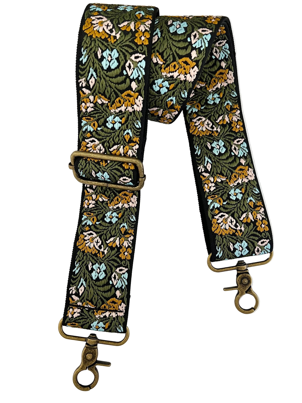 A floral patterned fabric strap with antique bronze metal hardware, laid flat on a white background. The strap features a dense botanical print of green leaves, yellow and orange flowers, and light blue blossoms on a black base, with matching black edging.